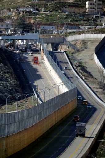 Cars drive along the Palestinian (R) and Israeli (L) lanes of Route 4370 in East Jerusalem on January 10, 2019