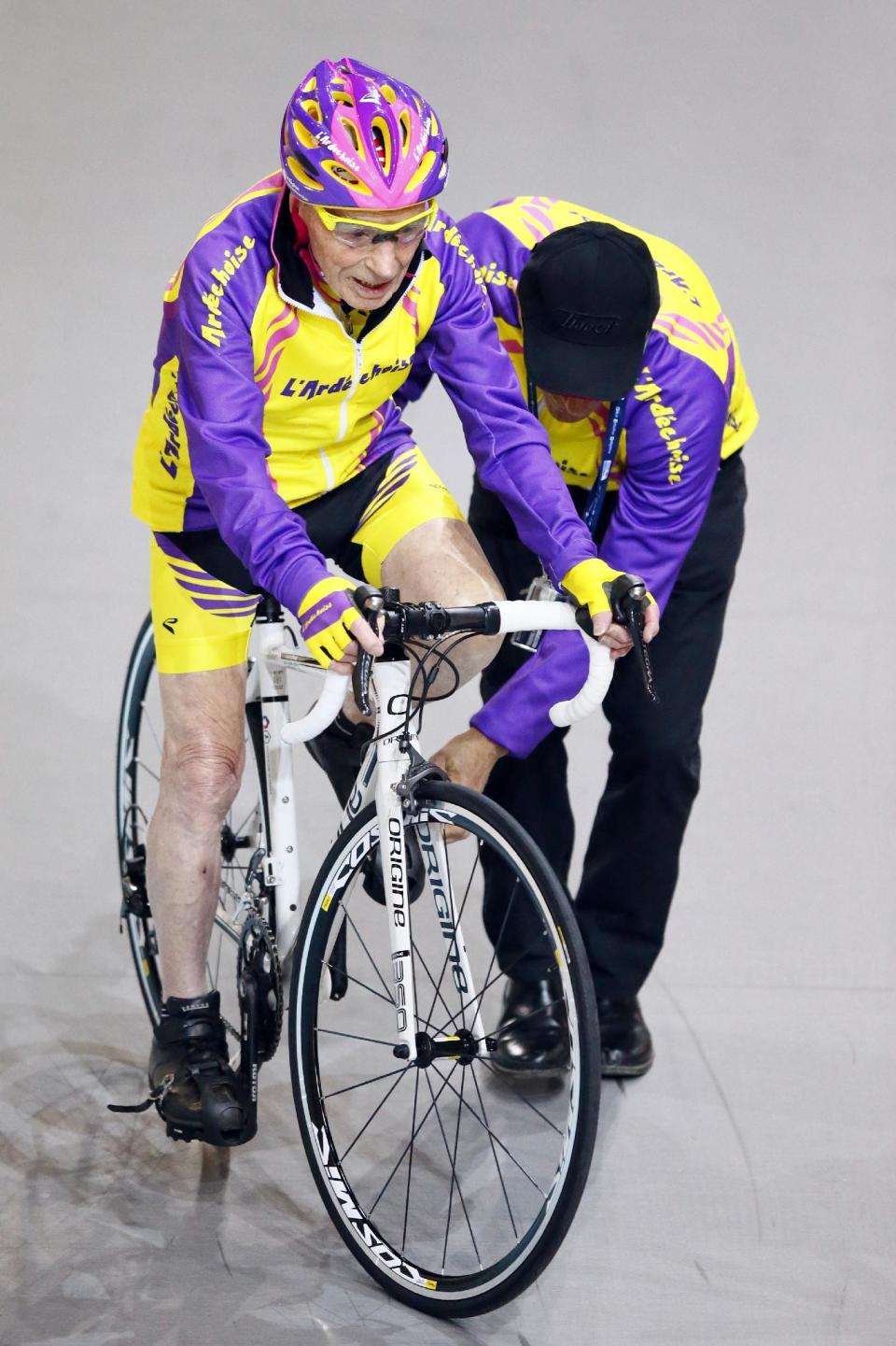 French cyclist Robert Marchand, aged 105, prepares to warm up prior to cycle in a bid to beat his record for distance cycled in one hour, at the velodrome of Saint-Quentin en Yvelines, outside Paris, Wednesday, Jan. 4, 2017. (AP Photo/Francois Mori)