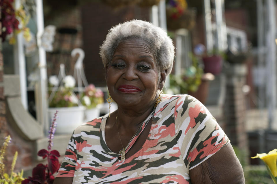 Pamela Jackson-Walters sits outside her home in Detroit, Wednesday, Sept. 21, 2022. Jackson-Walters uses her home internet connection to attend church services virtually and to pursue a graduate degree, but the service AT&T offers in her mostly Black neighborhood is much slower than in other parts of the city. She said she also experienced an internet outage for four weeks during the summer. (AP Photo/Paul Sancya)