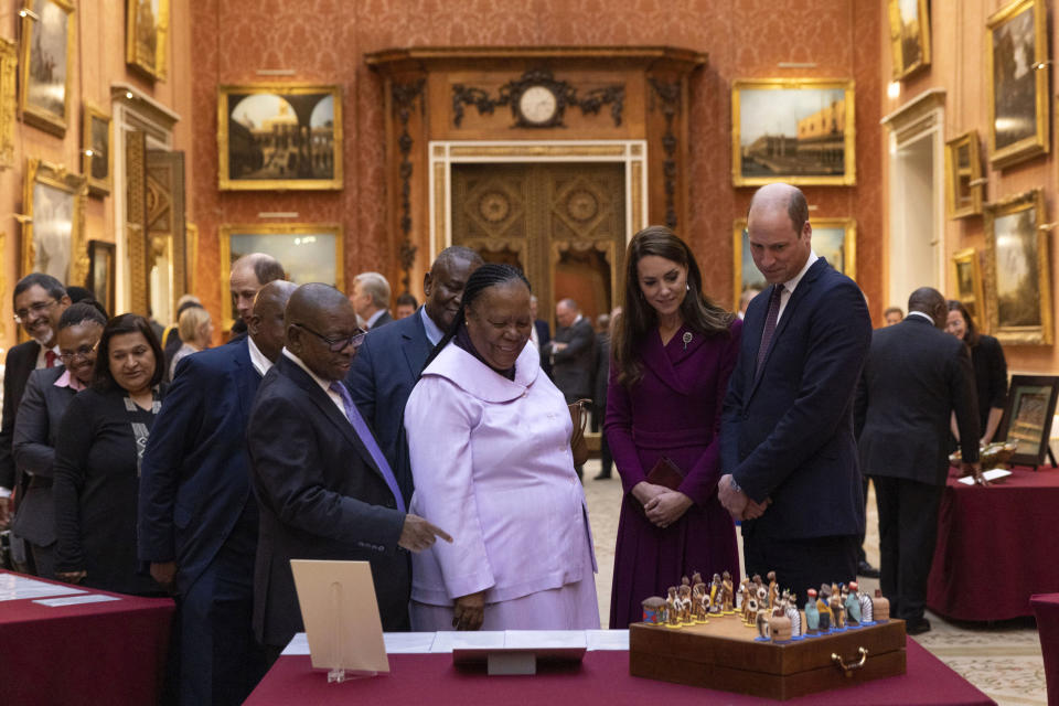 Britain's Prince William, right, and Kate, Princess of Wales escort Dr. Naledi Pandor, Minister of International Relations and Cooperation, third right, during a visit to view items, including a a chess set, which was a gift from President Nelson Mandela to Prince Philip in 1996, as part of a display of South African items from the Royal Collection at Buckingham Palace, London, Tuesday Nov. 22, 2022, during the two day state visit to the UK by the South African president. (Dan Kitwood/Pool via AP)