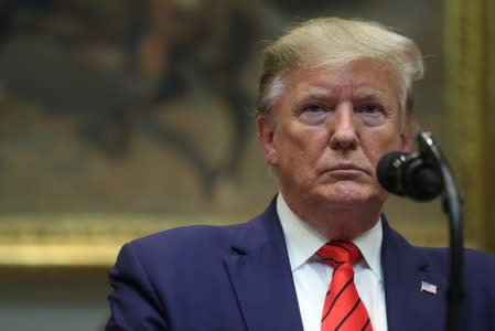 U.S. President Donald Trump speaks to reporters after signing executive orders on federal regulation at the White House in Washington