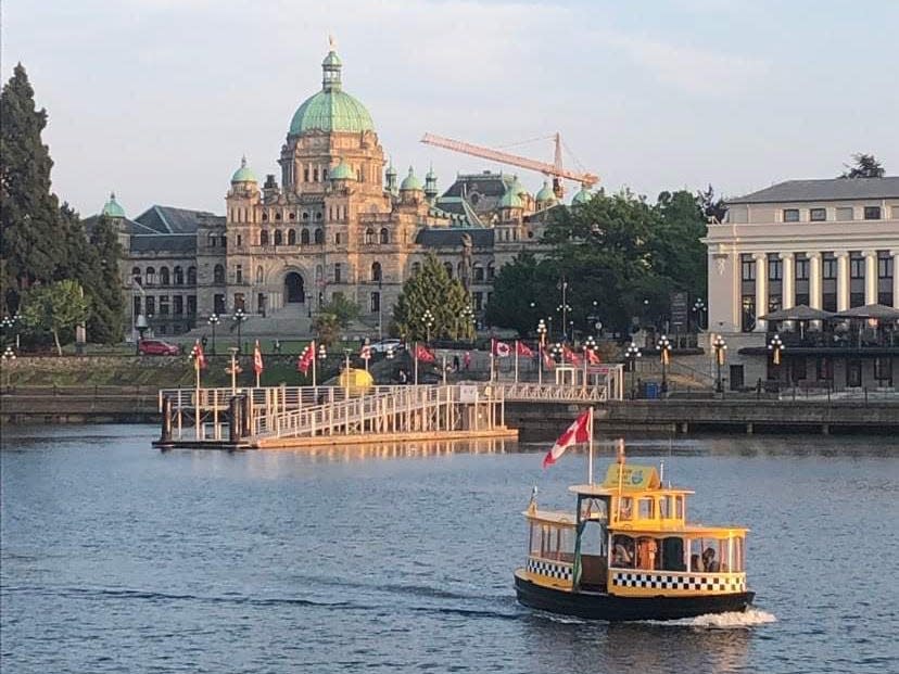 view of the city and municipal buildings on the other side of a waterway in victoria canada