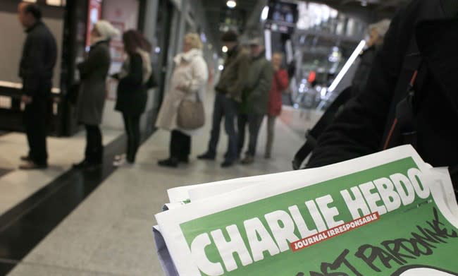 People queue up to buy the new issue of Charlie Hebdo newspaper in Paris Jan. 14, 2015. (AP)