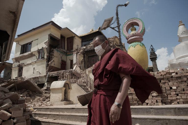 A Buddhist monk walks through the damaged Swayambunath Temple in Kathmandu, following a 7.8-magnitude earthquake which struck the Himalayan nation on April 25