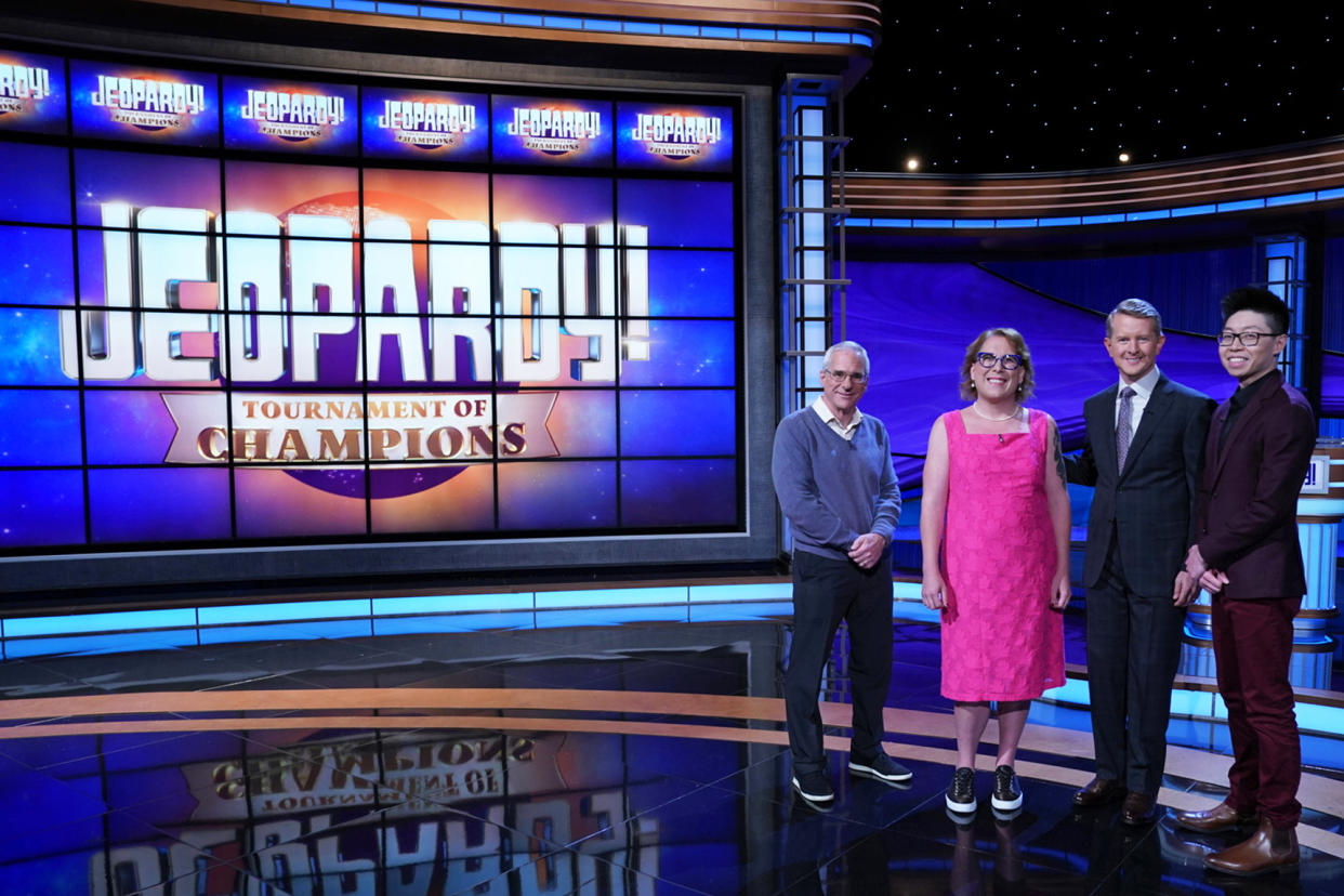 Contestants Sam Buttrey, Amy Schneider and Andrew He stand with Jeopardy! host Ken Jennings. (Tyler Golden / Sony Pictures Television)