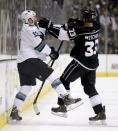 San Jose Sharks left wing Raffi Torres, left, and Los Angeles Kings defenseman Willie Mitchell fight during the first period in Game 4 of an NHL hockey first-round playoff series in Los Angeles, Thursday, April 24, 2014. (AP Photo/Chris Carlson)