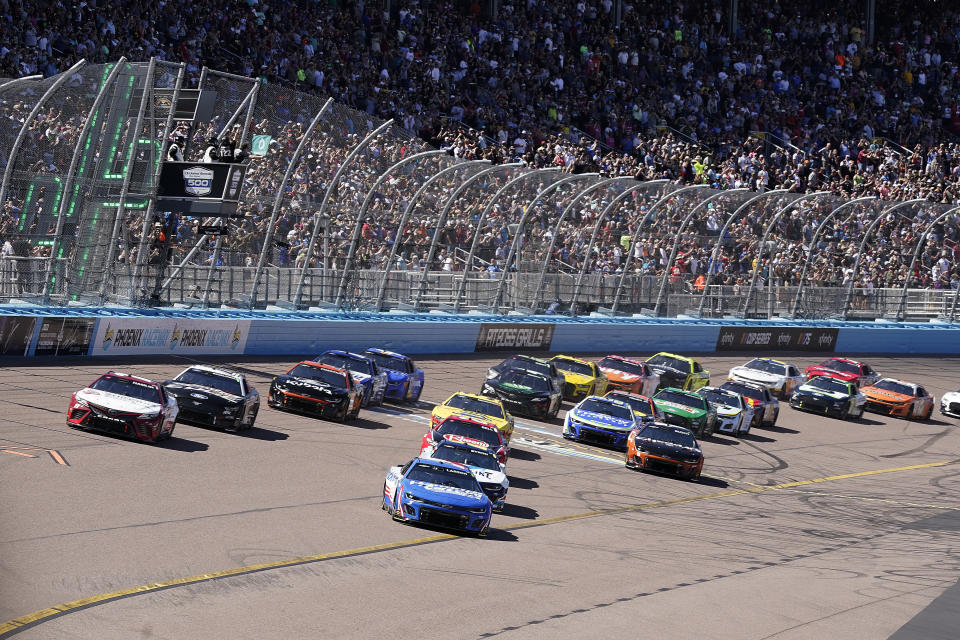 Cars take the starting flag during the NASCAR Cup Series auto race at Phoenix Raceway, Sunday, March 12, 2023, in Avondale, Ariz. (AP Photo/Darryl Webb)