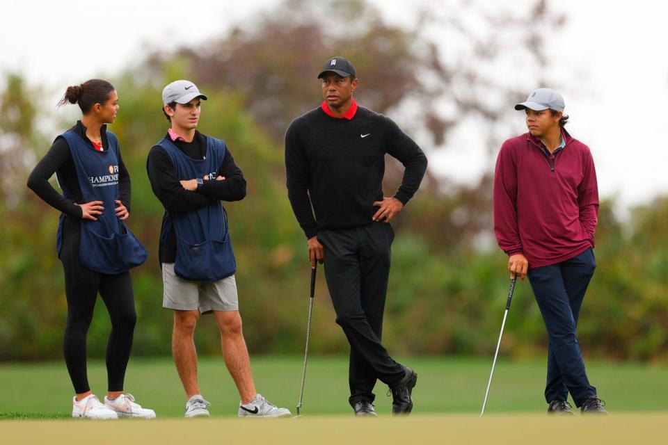 PHOTO: Tiger Woods of the United States looks on with son, Charlie Woods, daughter, Sam Woods, and caddie, Luke Wise, on the third green during the final round of the PNC Championship at The Ritz-Carlton Golf Club on December 17, 2023 in Orlando, Florida. (Mike Ehrmann/Getty Images)