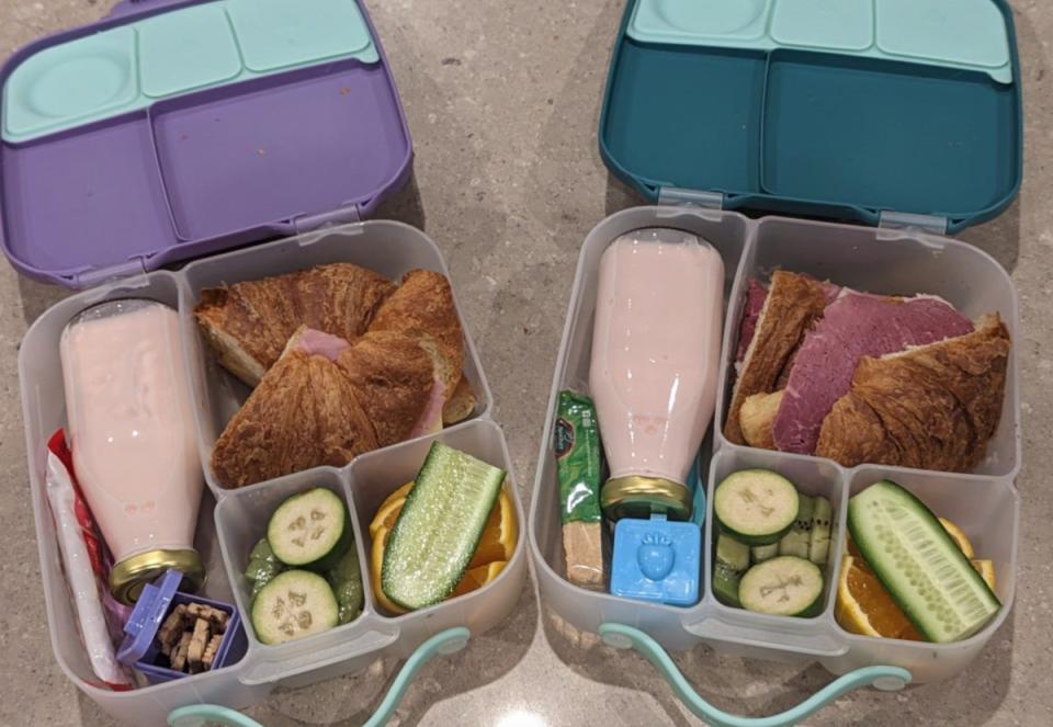 2 x Bento lunchbox filled with croissant, fruit veg and glass bottles of flavoured milk