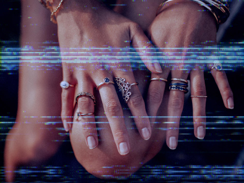a person's hands with rings on it
