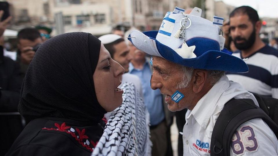 A pro-Palestinian woman and a pro-Israeli man shouting at each other