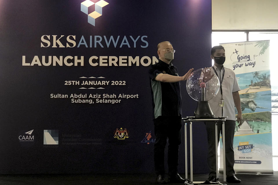 Malaysia's Transport Minister Wee Ka Siong, left, and SKS Airways Director Rohman Ahmad attend a launching ceremony at Subang terminal in Kuala Lumpur, Malaysia, Tuesday, Jan. 25, 2022. New low-cost Malaysian carrier, SKS Airways, took to the skies Tuesday with short-haul flights to holiday island resorts as domestic travel rebounds after months of lockdown due to the COVID-19 pandemic last year. (AP Photo/Eileen Ng)
