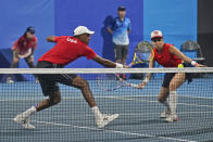 United States mixed doubles team of Bethanie Mattek-Sands, right, and Rajeev Ram play a German team during the first round of the tennis competition at the 2020 Summer Olympics, Wednesday, July 28, 2021, in Tokyo, Japan. (AP Photo/Seth Wenig)