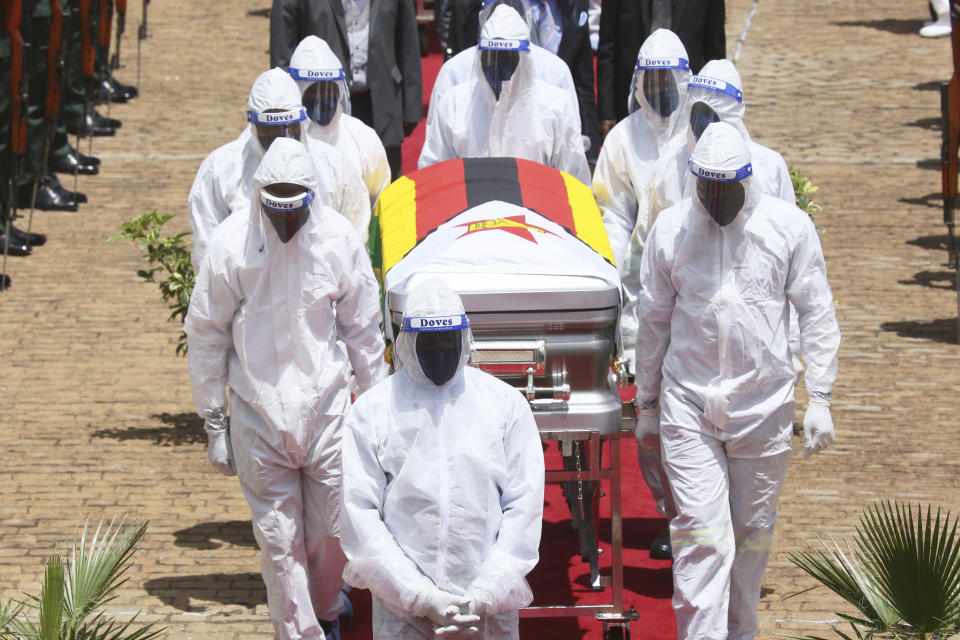 burial of Dr Ellen Gwaradzimba who died of COVID-19, at the Heroes Acre in Harare, Thursday, Jan. 21, 2021. Zimbabwean President Emmerson Mnangagwa who presided over the burial called the pandemic "evil" and urged people to wear masks, practice social distancing and sanitize, as cases across the country increased amid a fragile health system. (AP Photo/Tsvangirayi Mukwazhi)