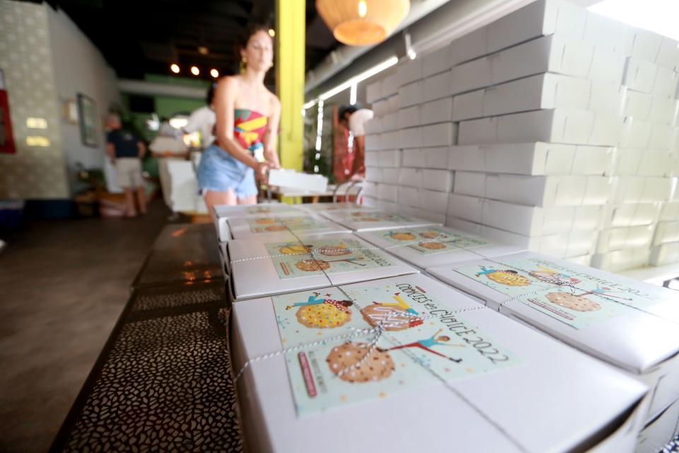 Volunteers stack boxes prepared for the Cookies for Choice fundraiser benefiting Planned Parenthood Southeast.