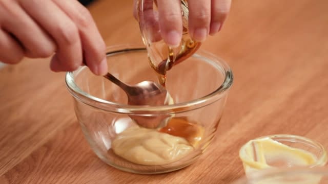 Mixing mustard and maple syrup together