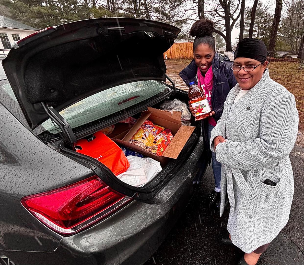 Saozenha Alves of Brockton, left, seen here with her aunt, visited the food pantry at North Baptist Church in Taunton on Saturday, March 23.