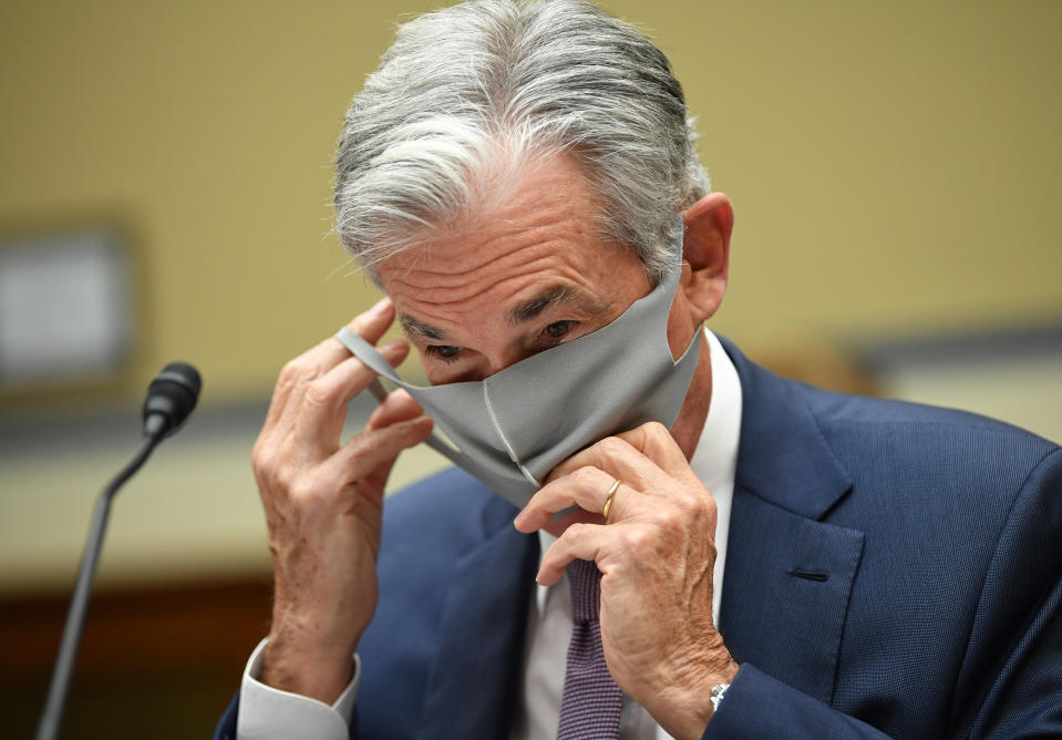 Federal Reserve Chair Jerome Powell puts on his face mask as he prepares to testify during a US Senate Senate Health, Education, Labor, and Pensions Committee hearing to examine covid-19, focusing on an update on the federal response in Washington, DC, on September 23, 2020. (Photo by KEVIN DIETSCH / various sources / AFP) (Photo by KEVIN DIETSCH/AFP via Getty Images)