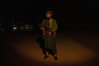 A Taliban fighter poses for a photo at a check point in Herat Afghanistan, on Saturday, Nov. 27, 2021. Since the Taliban's takeover of Afghanistan just over three months ago amid a chaotic withdrawal of U.S. and NATO troops, its fighters have changed roles, turning from fighting in the mountains and the fields to running the country. (AP Photo/ Petros Giannakouris)