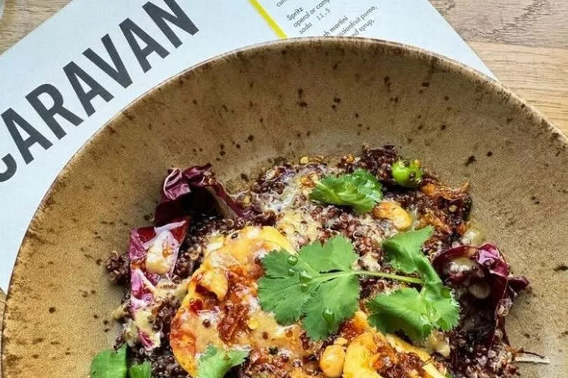 The halloumi grain bowl served with quinoa, roasted courgettes, edamame, cashew rayu, miso tahini, and sesame