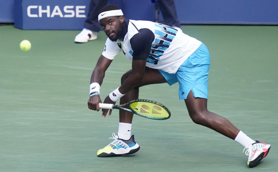 Frances Tiafoe, of the United States, returns a shot to Marton Fucsovics, of Hungary, during the third round of the US Open tennis championships, Saturday, Sept. 5, 2020, in New York. (AP Photo/Frank Franklin II)