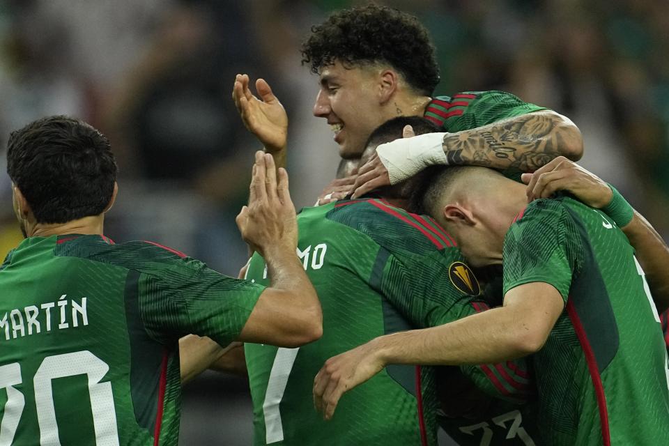 Mexico's Luis Romo (7) celebrates with teammates after scoring a goal against Honduras during the first half of a CONCACAF Gold Cup soccer match Sunday, June 25, 2023, in Houston. (AP Photo/David J. Phillip)