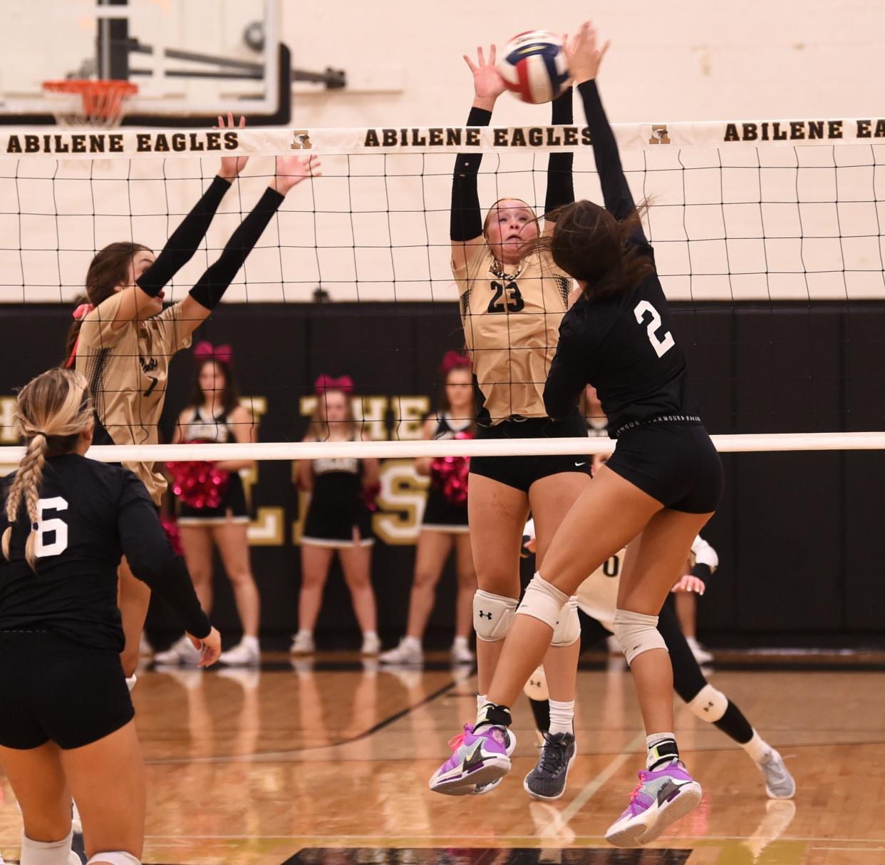 Abilene High's Allie Bennett (23) defends as Abilene Wylie's Taylar Riley hits the ball. Wylie beat the Lady Eagles 25-27, 25-15, 26-24, 25-21 in the District 4-5A match Oct. 3 at Eagle Gym.