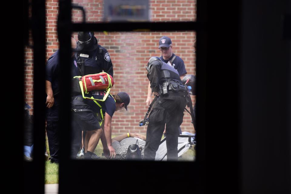 Port Huron Fire Department rescue crew member and Port Huron Police Department officers carry out an injured civilian out of the building during the active killer training on the campus of St. Clair County Community College in Port Huron on Tuesday, August 9, 2022.