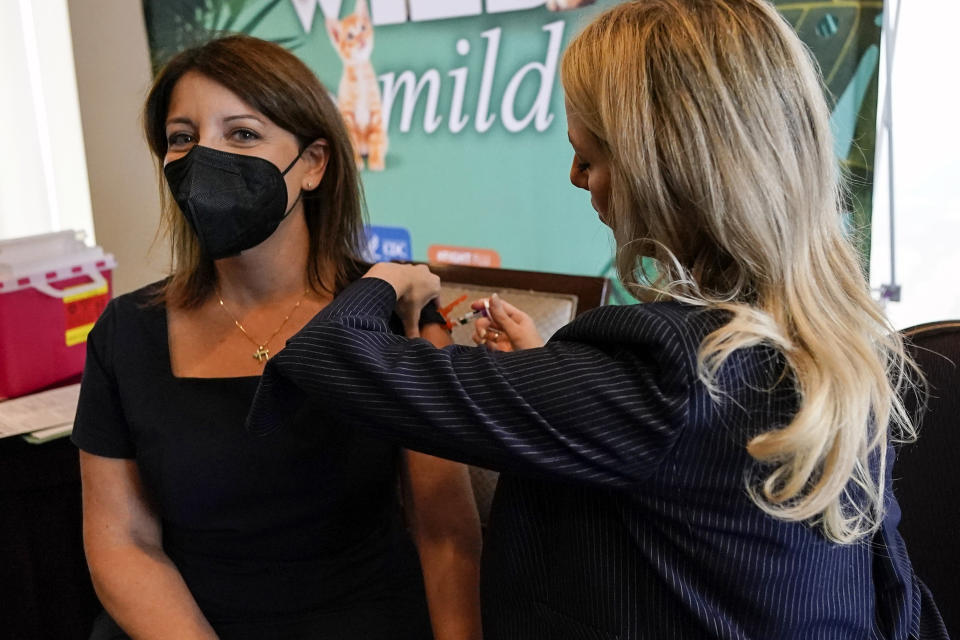 FILE - Dr. Mandy Cohen, director of the Centers for Disease Control and Prevention, receives a flu vaccine from Nurse Practitioner Whitney Goggans at the Atlanta Press Club, where Cohen spoke about health issues, Wednesday, Sept. 6, 2023, in Atlanta. Cohen says the U.S. is in “our strongest position yet” to avoid another chaotic respiratory season. “There will be a lot of virus this winter. That’s why we want to get ahead of it.” (AP Photo/Mike Stewart, File)