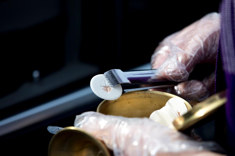 Holy Communion is distributed during a drive-thru service at Faith Lutheran Church on Ash Wednesday in 2021.