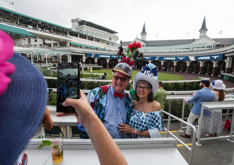 A Derby veteran since 1977, Skip Keopnick and wife Mary -- with a nod to the 150th Run For the Roses on her hat -- get their photo snapped by a guest inside the Churchill Downs' Paddock on Kentucky Derby day Saturday, May 4, 2024 in Louisville, Kentucky. On a card he gives out, he's quoted as "There are no bad Derbys. Some are just better than others." Skip made his hat which has a revolving Derby horse.