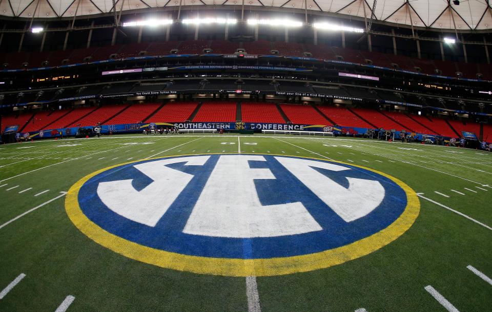 FILE - In this Dec. 5, 2014, file photo, SEC logo is displayed on the field ahead of the Southeastern Conference championship football game between Alabama and Missouri in Atlanta. History and tradition? Those terms carry no weight in what has essentially become a game of Risk, with the Big Ten and Southeastern Conference taking turns rolling the dice to determine how to divvy up the world of college football. (AP Photo/John Bazemore, File)