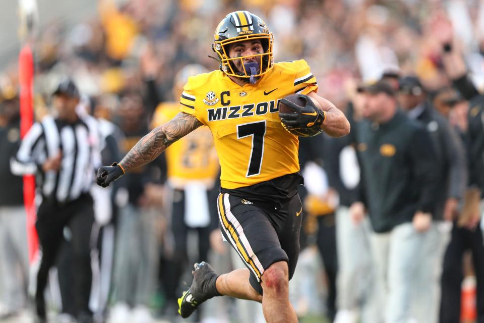 Nov 24, 2023; Fayetteville, Arkansas, USA; Missouri Tigers running back Cody Schrader (7) rushes against the Arkansas Razorbacks during the second quarter at Donald W. Reynolds Razorback Stadium. Mandatory Credit: Nelson Chenault-USA TODAY Sports