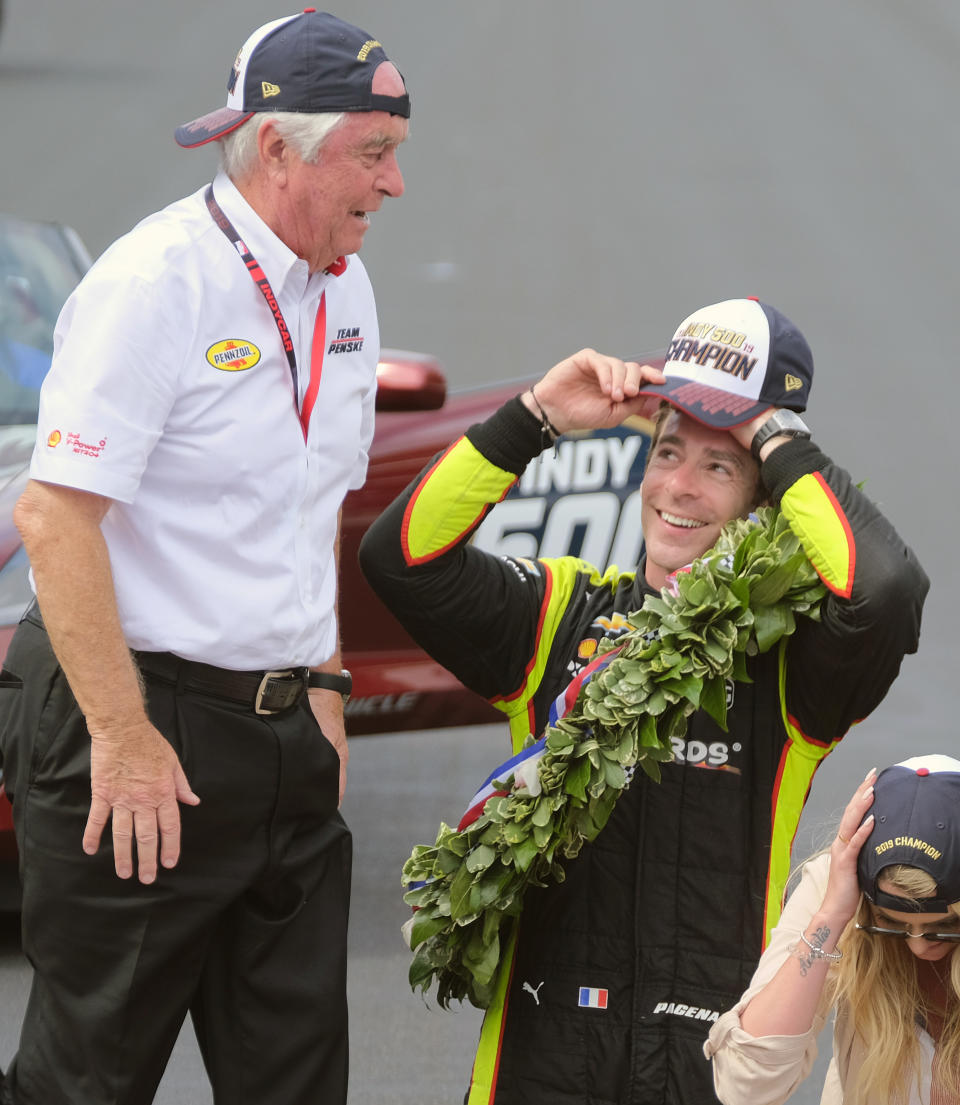 Simon Pagenaud, of France, talks with car owner Roger Penske as they celebrate on the Yard of Bricks after Pagenaud won the Indianapolis 500 IndyCar auto race at Indianapolis Motor Speedway, Sunday, May 26, 2019, in Indianapolis. (AP Photo/AJ Mast)