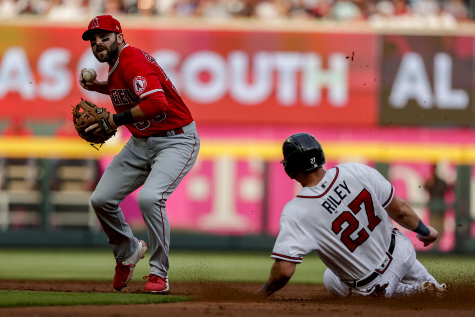 Los Angeles Angels second baseman Michael Stefanic, left, looks to throw to first after getting the force out on Atlanta Braves' Austin Riley (27) during the first inning of a baseball game Saturday, July 23, 2022, in Atlanta. (AP Photo/Butch Dill)