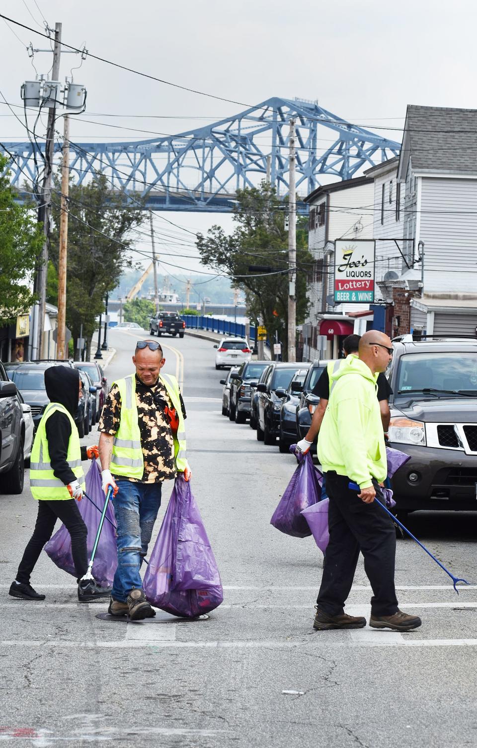 Workers picking up trash on Hope Street in Fall River are part of a pilot program aimed at getting homeless residents back into the workforce.