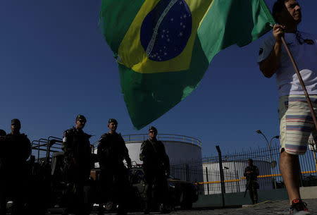 Brazil's Army soldiers patrol outside a fuel distribution center as truckers attend a protest against high diesel fuel prices in Duque de Caxias near Rio de Janeiro, Brazil May 27, 2018. REUTERS/Ricardo Moraes