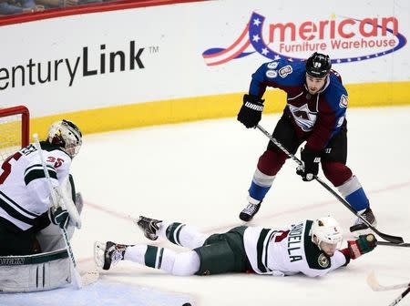 Colorado Avalanche center Ryan O'Reilly (90) attempts on a shot on Minnesota Wild goalie Darcy Kuemper (35) as defenseman Marco Scandella (6) falls in the second period in game seven of the first round of the 2014 Stanley Cup Playoffs at Pepsi Center. Apr 30, 2014; Denver, USA; Ron Chenoy-USA TODAY Sports -