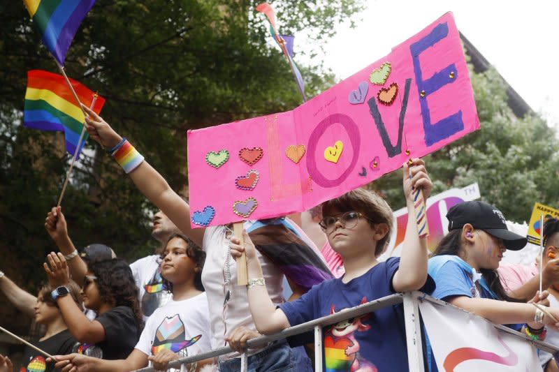 Participants hold signs and wave flags during the Pride March in New York City on Sunday. Photo by John Angelillo/UPI