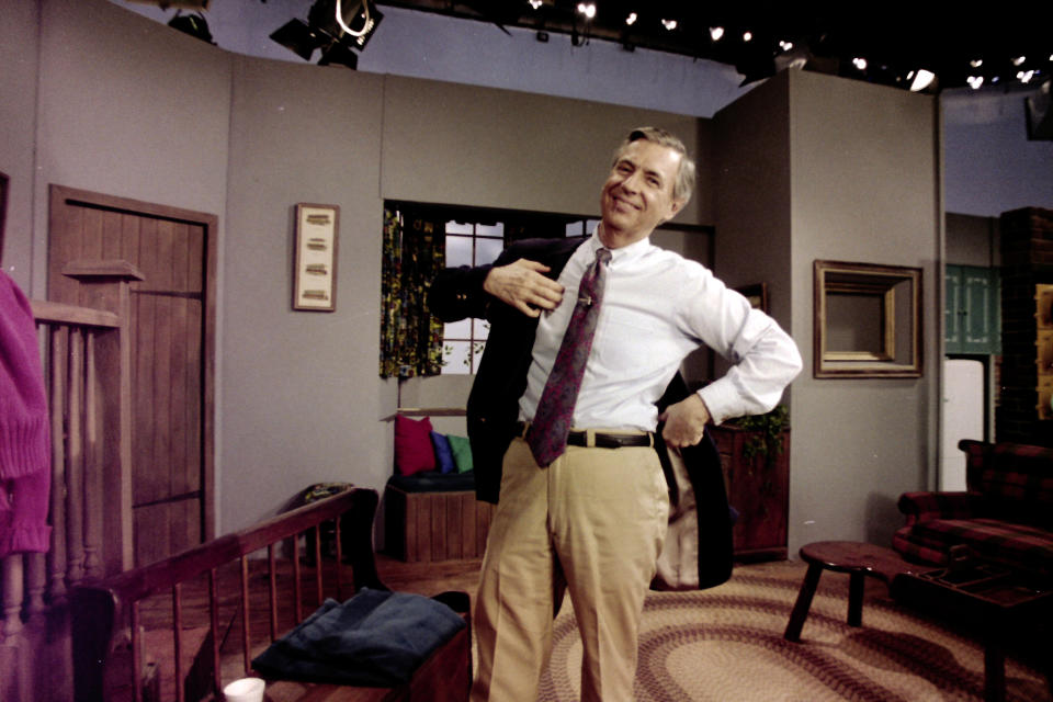 Fred Rogers puts on his jacket between takes on the set of his television program "Mister Rogers' Neighborhood" in Pittsburgh on June 8, 1993. (AP Photo/Gene J. Puskar)
