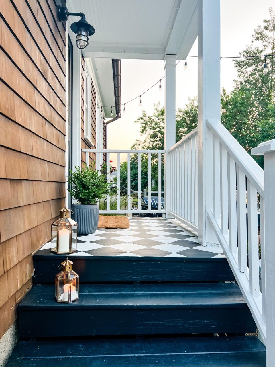 a porch with a white railing and a white railing