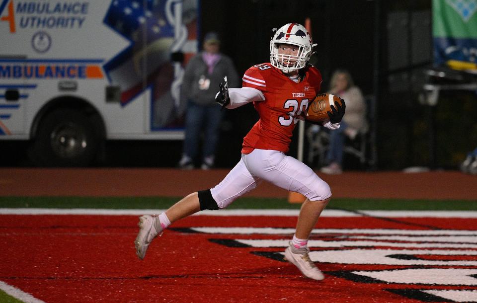 Tavis Lindsay #39 of the Moon Tigers goes into the end zone for a touchdown in the first half during the game against the Bethel Park Black Hawks at Tiger Stadium on Friday Night in Moon Township, Pennsylvania.