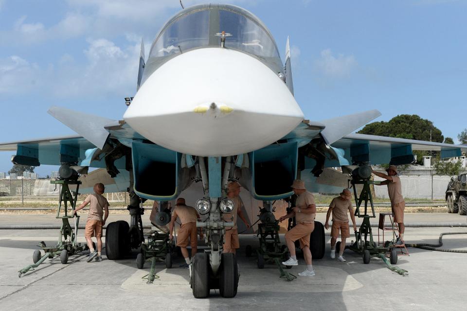 Russian servicemen repair a Su-34 at an airbase in Syria.