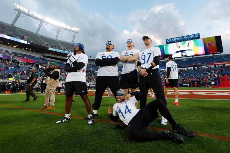 Detroit Lions' Amon-Ra St. Brown (14) poses with Lions teammates from left to right: Jahmyr Gibbs, Penei Sewell, Aidan Hutchinson and Sam LaPorta, after the NFC defeated the AFC in the NFL Pro Bowl Games at Camping World Stadium on Feb. 4, 2024 in Orlando.