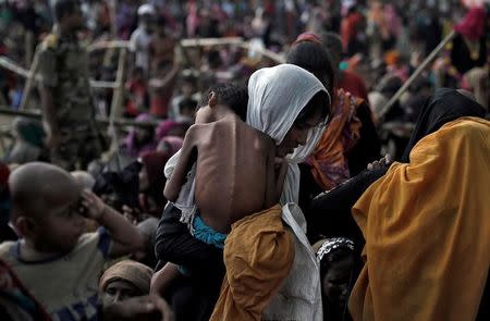 A woman carries her ill child in a refugee camp at Cox's Bazar, Bangladesh, September 26, 2017. Reuters photographer Cathal McNaughton/Files