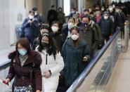 Passengers arriving from the Chinese city of Wuhan arrive at Narita Airport in Chiba