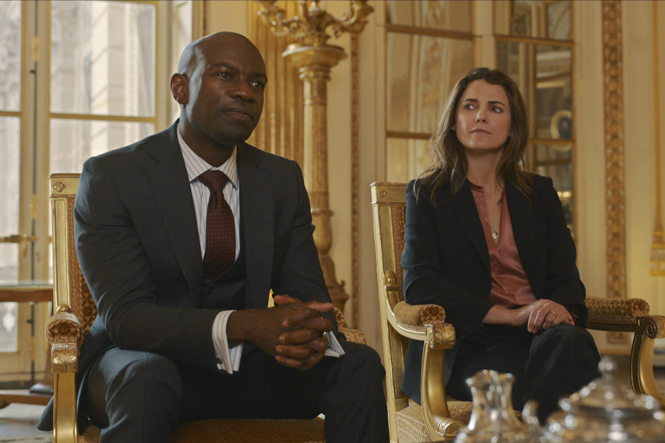 This image released by Netflix shows David Gyasi as Austin Dennison, left, and Keri Russell as Ambassador Kate Wyler in a scene from "The Diplomat." (Netflix via AP)
