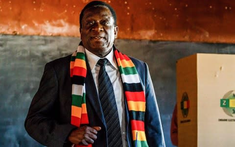 Emmerson Mnangagwa stands after casting his ballot at Sherwood Primary School in Kwekwe - Credit: JEKESAI NJIKIZANA/AFP