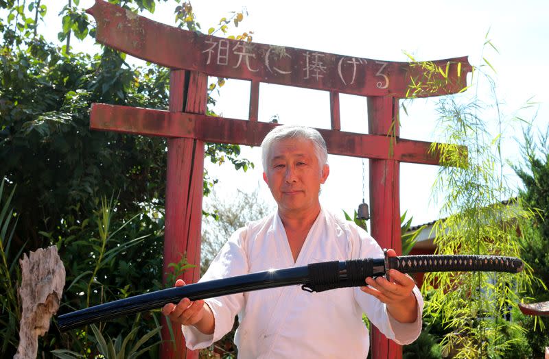 Samurai Suemitsu shows a katana sword at his home in Curitiba