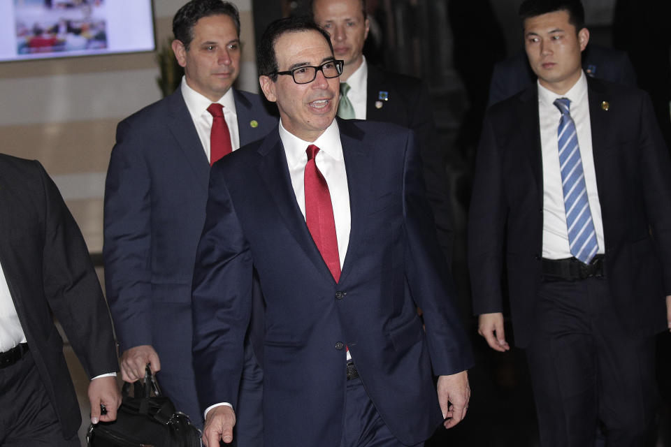 U.S. Treasury Secretary Steven Mnuchin speaks to the media as he leaves a hotel in Beijing, Friday, March 29, 2019. U.S. trade negotiators lead by Mnuchin and Trade Representative Robert Lighthizer arrived in Beijing to start a new round of talks aimed at ending a tariff war over China's technology ambitions as officials hint they might be making progress. (AP Photo/Andy Wong)